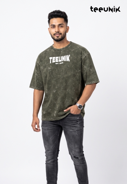 A green acid-wash streetwear t-shirt featuring a dropped shoulder design, relaxed fit, and the white TEEUNIK EST. 2023 logo.